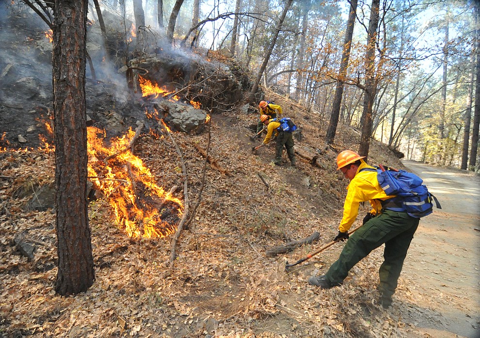 Fire crews work the one-acre Empire Fire in Groom Creek Tuesday afternoon. (Les Stukenberg/Courier)