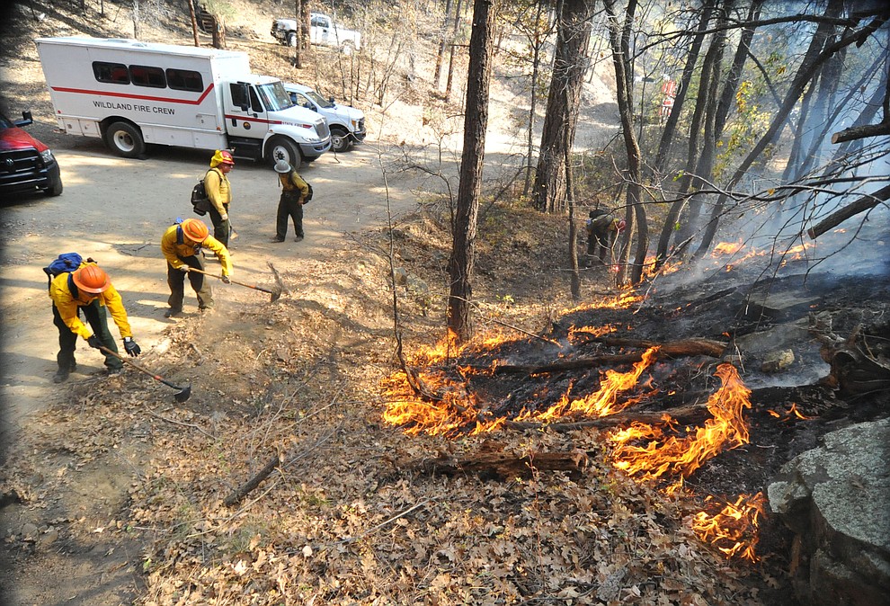 Fire crews work the one-acre Empire Fire in Groom Creek Tuesday afternoon. (Les Stukenberg/Courier)