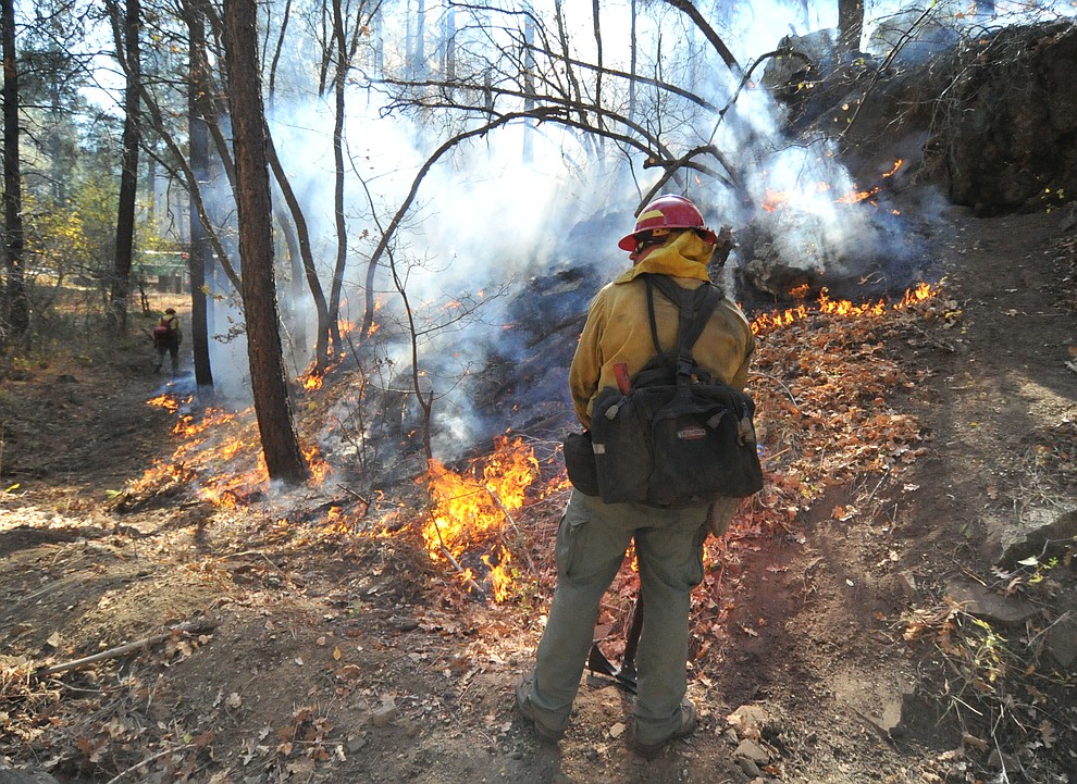 Fire crews work the one-acre Empire Fire in Groom Creek Tuesday afternoon. (Les Stukenberg/Courier)