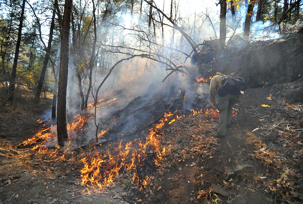 Fire crews work the one-acre Empire Fire in Groom Creek Tuesday afternoon. (Les Stukenberg/Courier)