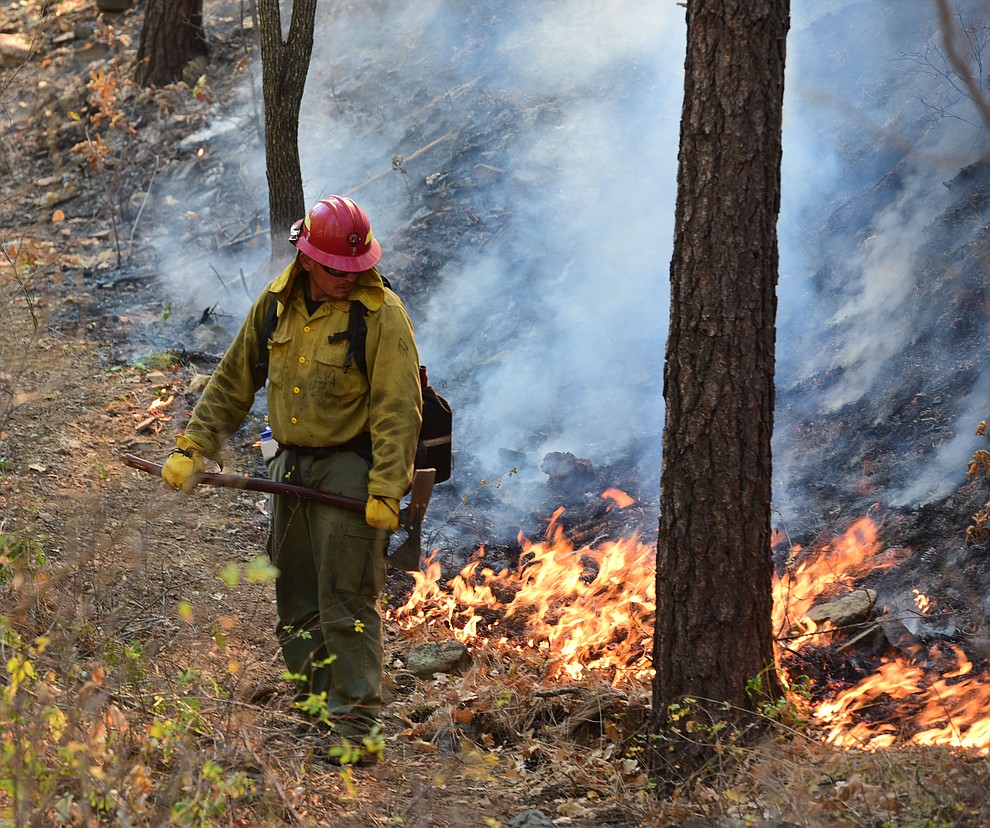 Fire crews work the one-acre Empire Fire in Groom Creek Tuesday afternoon. (Les Stukenberg/Courier)