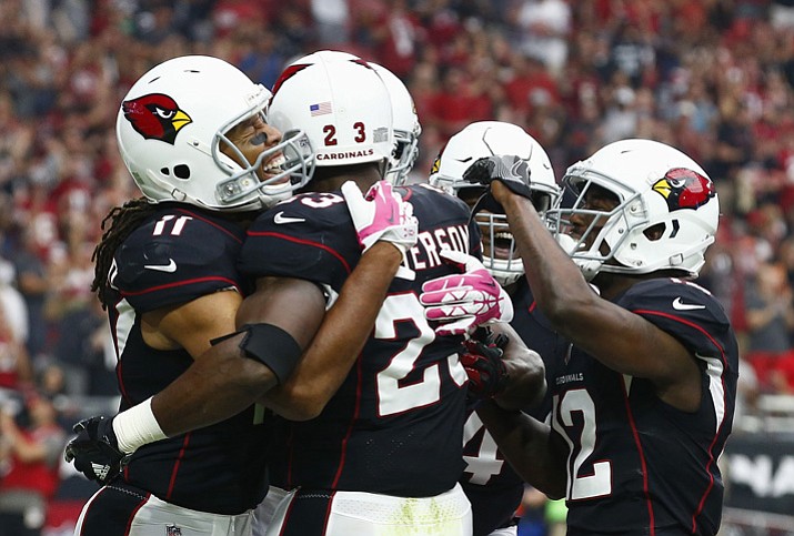 Arizona Cardinals running back Adrian Peterson (23) celebrates his touchdown against the Tampa Bay Buccaneers with wide receiver Larry Fitzgerald (11), wide receiver John Brown (12), and other teammates during the first half Sunday, Oct. 15, 2017, in Glendale. (Ralph Freso/AP)