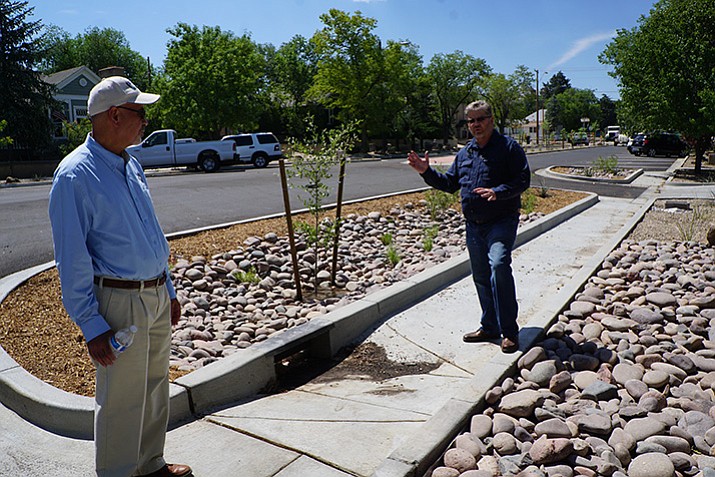 In this file photo from July 2017, Prescott City Engineer Charles Andrews (right) explained the purpose of the bio-basin drainage areas that were added as a part of the Alarcon Street reconstruction, while Public Works Director Henry Hash, left, looked on. The landscaped bio-basins are intended to filter out pollutants in runoff water before the water gets to area creeks. (Cindy Barks/Courier)