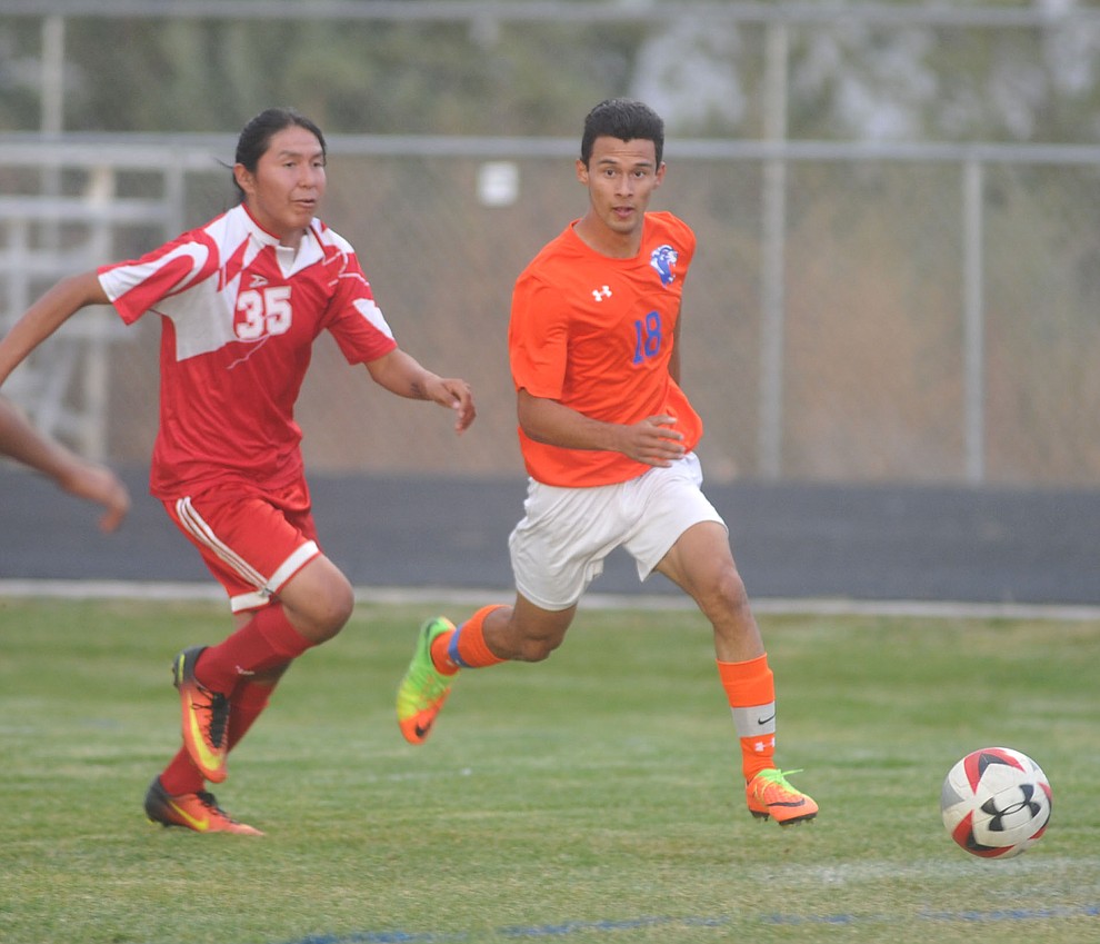 Chino Valley's Jairo Herrera (18) looks to center the ball as the Cougars take on the Grand Canyon Phantoms Wednesday night in Chino Valley. (Les Stukenberg/Courier)