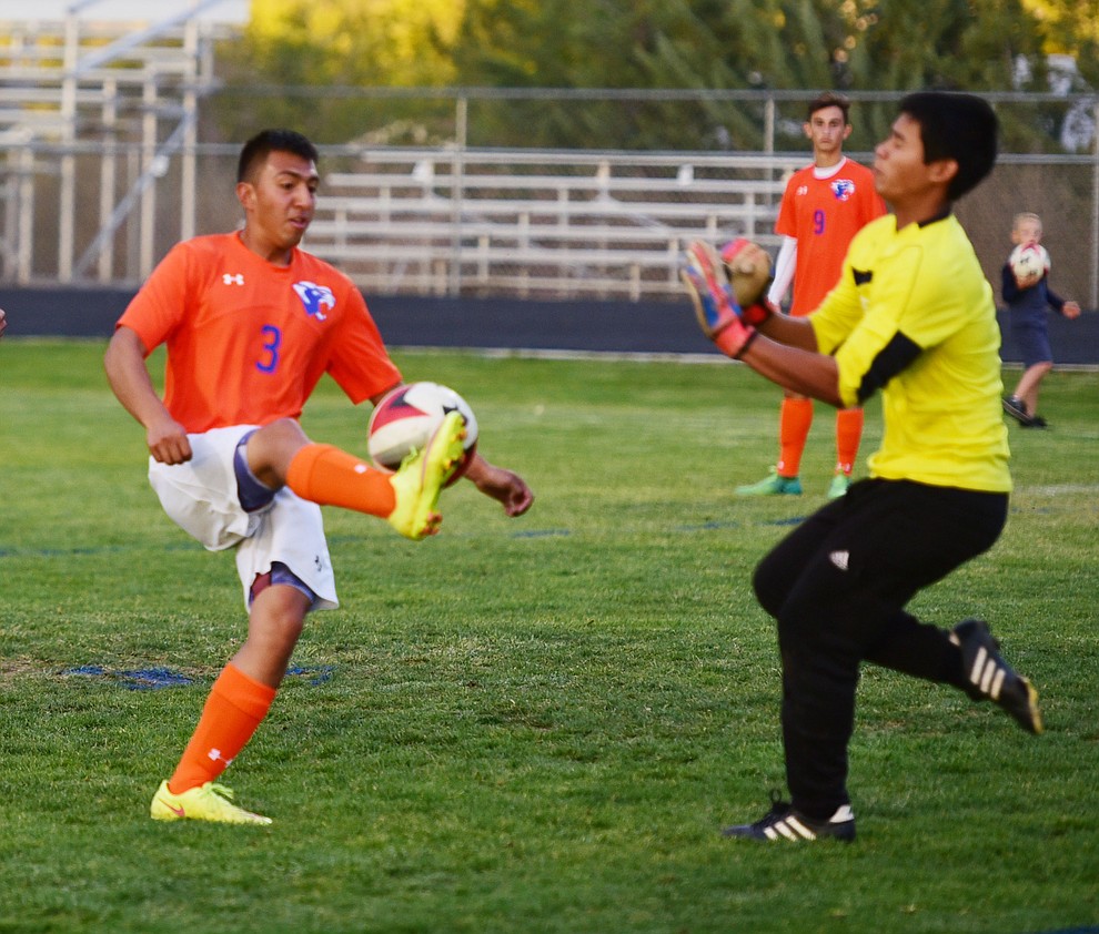 Chino Valley's Arlin Pina (3) kicks the ball over the goalie as the Cougars take on the Grand Canyon Phantoms Wednesday night in Chino Valley. (Les Stukenberg/Courier)