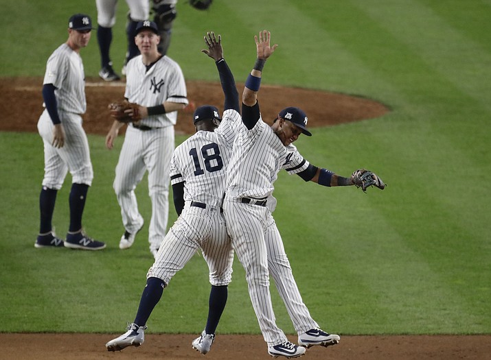 New York Yankees’ Didi Gregorius and Starlin Castro celebrate after Game 5 of baseball’s American League Championship Series against the Houston Astros Wednesday, Oct. 18, in New York. The Yankees won 5-0 to take a 3-2 lead in the series. (Frank Franklin II/AP)