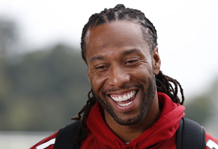 Wide receiver Larry Fitzgerald of the Arizona Cardinals laughs as he is interviewed after a press conference ahead of an NFL training session at the London Irish rugby team training ground in the Sunbury-on-Thames, suburb of south west London, Thursday, Oct. 19, 2017. The Arizona Cardinals are preparing for an NFL regular season game against the Los Angeles Rams in London on Sunday. (Kirsty Wigglesworth/AP)