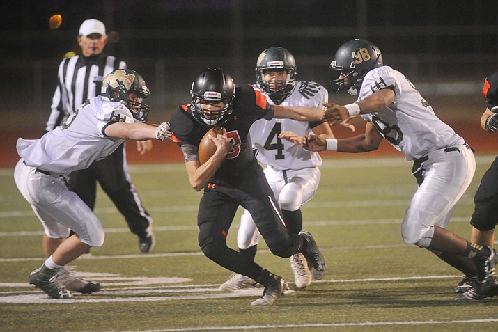 Bradshaw Mountain's Austin Gonzalez evades tacklers as the Bears play Mohave in ther final home game of the year in Prescott Valley Friday night. (Les Stukenberg/Courier)