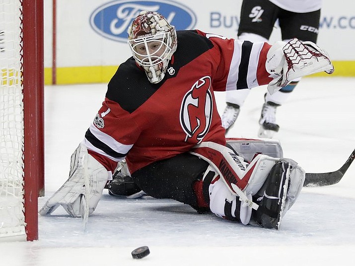 New Jersey Devils goalie Keith Kinkaid watches as a shot by the San Jose Sharks bounces off the post during the first period of an NHL hockey game, Friday, Oct. 20, 2017, in Newark, N.J. (AP Photo/Julio Cortez)