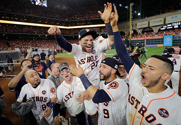 Houston Astros’ Jose Altuve is lifted by teammates after Game 7 of baseball’s American League Championship Series against the New York Yankees Saturday, Oct. 21, in Houston. The Astros won 4-0 to win the series. (David J. Phillip/AP)
