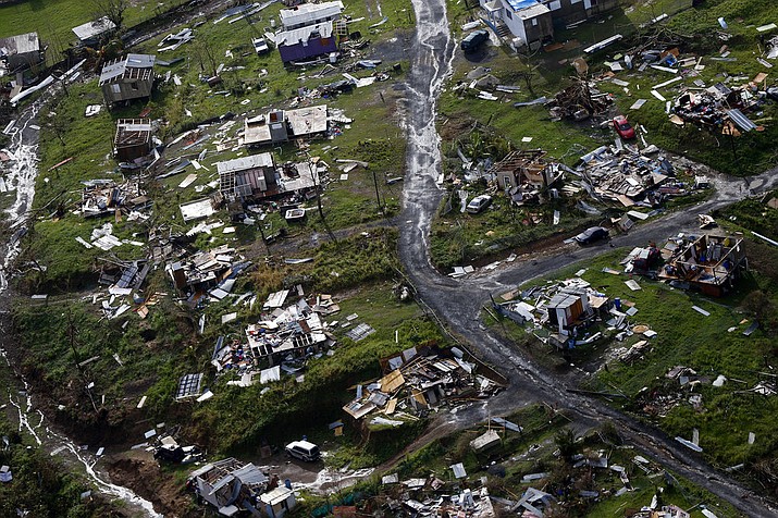 In this Sept. 28, 2017, file photo, debris scatters a destroyed community in the aftermath of Hurricane Maria in Toa Alta, Puerto Rico. The Senate is pushing ahead on a $36.5 billion hurricane relief package that would give Puerto Rico a much-needed infusion of cash but rejects requests from the powerful Texas and Florida congressional delegations for additional money to rebuild after hurricanes Harvey and Irma. The measure is sure to sail through a Monday, Oct. 23, procedural vote and a final vote is expected no later than Tuesday. (AP Photo/Gerald Herbert, File)