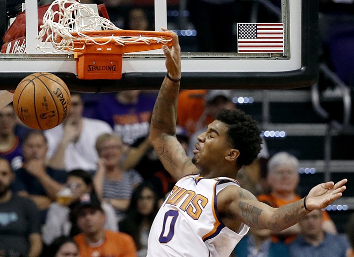 Phoenix Suns forward Marquese Chriss (0) dunks over Sacramento Kings forward Zach Randolph (50) during the first half of an NBA basketball game, Monday, Oct. 23, 2017, in Phoenix. (Matt York/AP)