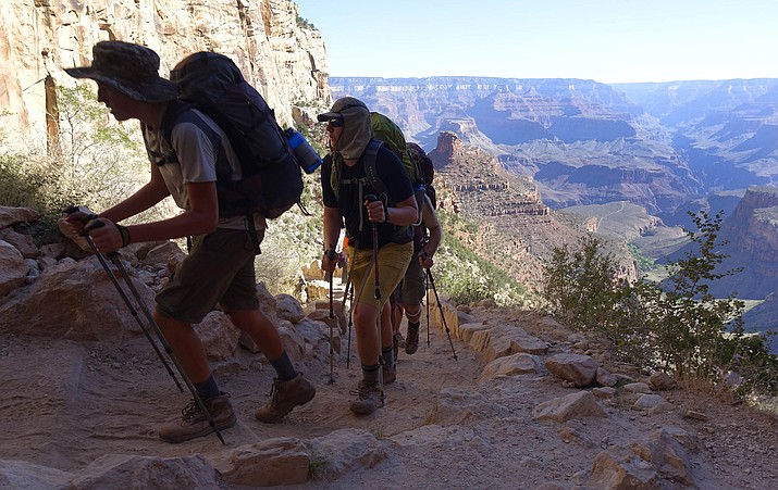 A long line of hikers head out of the Grand Canyon along the Bright Angel Trail at Grand Canyon National Park, Ariz. The National Park Service is floating a proposal to increase entrance fees at 17 of its most popular sites next year. (AP Photo/Ross D. Franklin, File)

