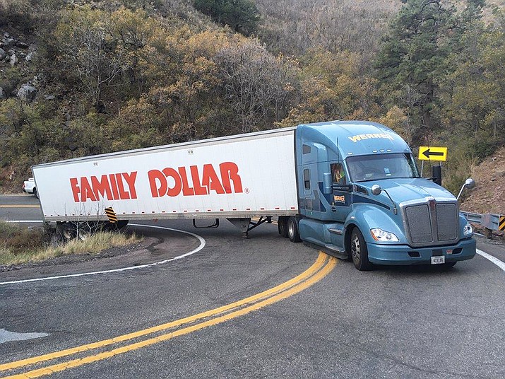 A 53-foot Family Dollar tractor-trailer, failing to negotiate a hairpin turn on Mingus Mountain about 13 miles south of Jerome, became disabled and halted traffic for three hours Wednesday morning. (Photo Courtesy of ADOT)