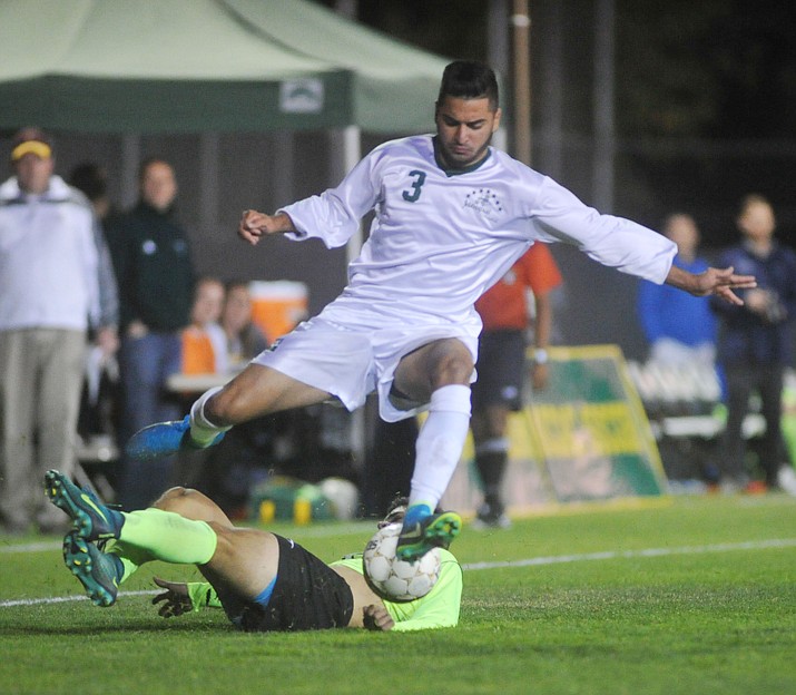 Yavapai’s Ziyad Fares (3) jumps over a defender as the Roughriders take on Phoenix College in the semifinals of the NJCAA Region 1 soccer tournament in Prescott Wednesday night.