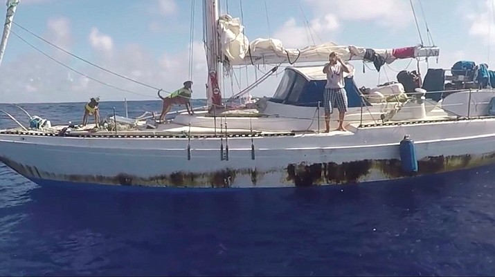 Jennifer Appel, of Honolulu, blows kisses as rescuers approach her crippled sailboat, the Sea Nymph, after being lost at sea for months, about 900 miles southeast of Japan. Their engine was crippled, their mast was damaged and things went downhill from there for two women who set out to sail the 2,700 miles from Hawaii to Tahiti. A Taiwanese fishing vessel spotted their boat off Japan and thousands of miles in the wrong direction from Tahiti. The Navy sent the USS Ashland to their rescue. (U.S. Navy via AP)