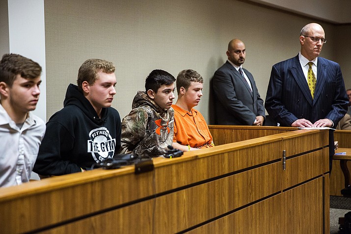 From left to right, Trevor Gray, 15, Alexzander Miller, 15, Mikadyn Payne, 16, and Kyle Anger, 17, all of Clio, Mich., appear for their arraignment in front of Judge William Crawford on Tuesday, Oct. 24, 2017, in Genesee County District Court in downtown Flint, Mich. Along with Clio resident Mark Sekelsky, 16, not pictured, the teenagers are charged with second-degree murder in a rock-throwing incident on Interstate 75. (Terray Sylvester /The Flint Journal-MLive.com via AP)