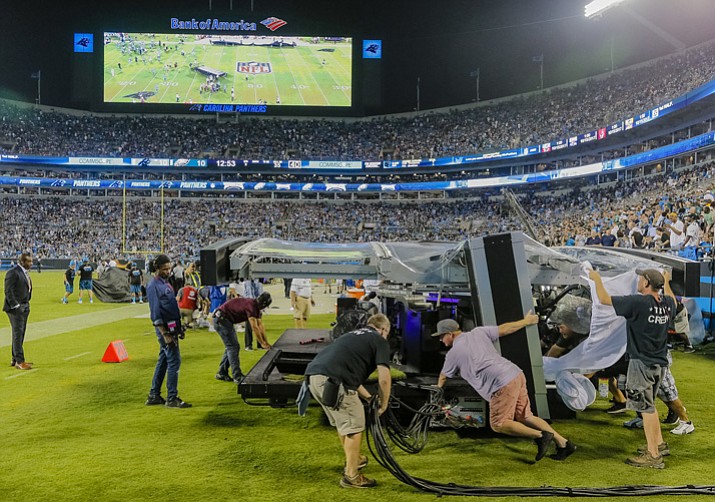 The Thursday Night Football crew pushes the TV set into action during halftime between the Philadelphia Eagles and Carolina Panthers on Thursday, Oct. 12, 2017, Charlotte, N.C. (Bob Leverone/AP)