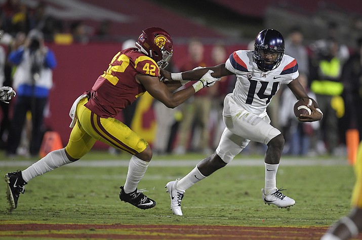 Arizona quarterback Khalil Tate, right, tries to escape a tackle by Southern California linebacker Uchenna Nwosu during the first half of an NCAA college football game, Saturday, Nov. 4, 2017, in Los Angeles. 
