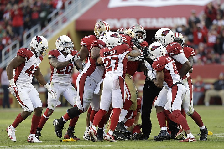 San Francisco 49ers offensive guard Laken Tomlinson, center, shoves Cardinals players during the second half of an NFL football game in Santa Clara, Calif., Sunday, Nov. 5. (Marcio Jose Sanchez/AP)