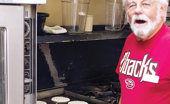 Lee Dudley of the Elks Lodge flips pancakes. (Troy Weigel/Courtesy)