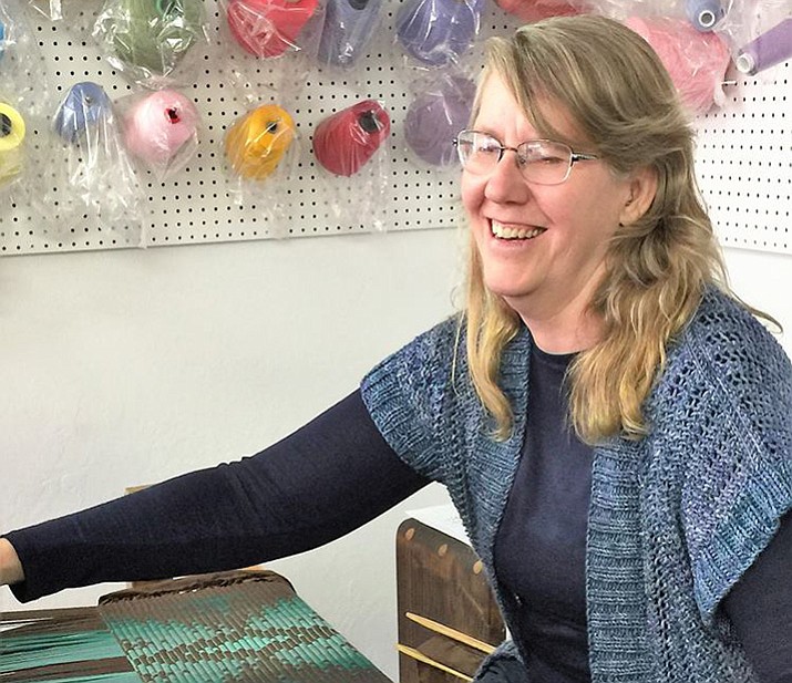 Guild president Nancy Dunlap works her magic on the loom with a woven rug. (Courtesy)