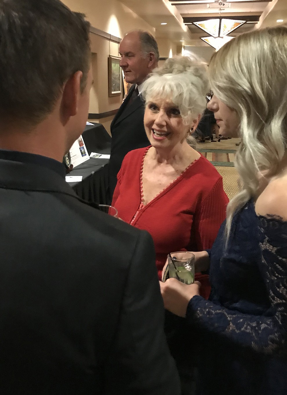 Alyce Ayers, director of Resource Development for Prescott Area Habitat for Humanity and chair of the 2017 Toolbelts & Tuxedos Gala Committee, talks with the event's guests on Saturday, Nov. 11, at the Prescott Resort. (Kelly Soldwedel/PNI)