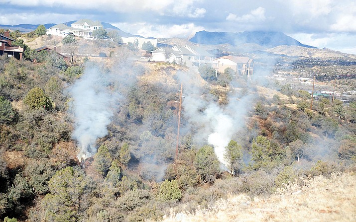 Arrow Fire Support Services LLC conducts a burn of slash piles in a canyon near Bradshaw Drive on Jan. 27, 2015, in Prescott. (Les Stukenberg/Courier, File)