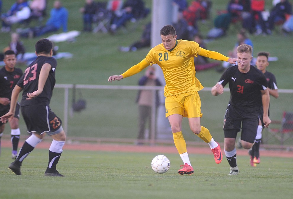 Yavapai's William Baynham maneuvers the ball between 4 defenders as the Roughriders take on Waubonsee Community College in the opening round of the NJCAA Division 1 National Championship Tuesday night in Prescott Valley. (Les Stukenberg/Courier)