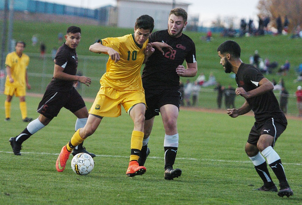 Yavapai's Carlo Quesada battles between three defenders as the Roughriders take on Waubonsee Community College in the opening round of the NJCAA Division 1 National Championship Tuesday night in Prescott Valley. (Les Stukenberg/Courier)
