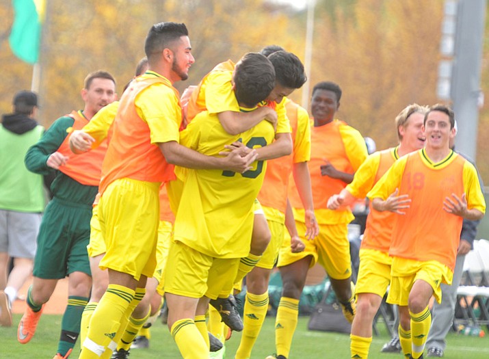 Yavapai’s Carlo Quesada (10) gets mobbed by his teammates after the first goal as the Roughriders take on Mercer County Community College in pool play of the NJCAA National Championship Tournament on Wednesday, Nov. 15, 2017, in Prescott Valley. (Les Stukenberg/Courier)