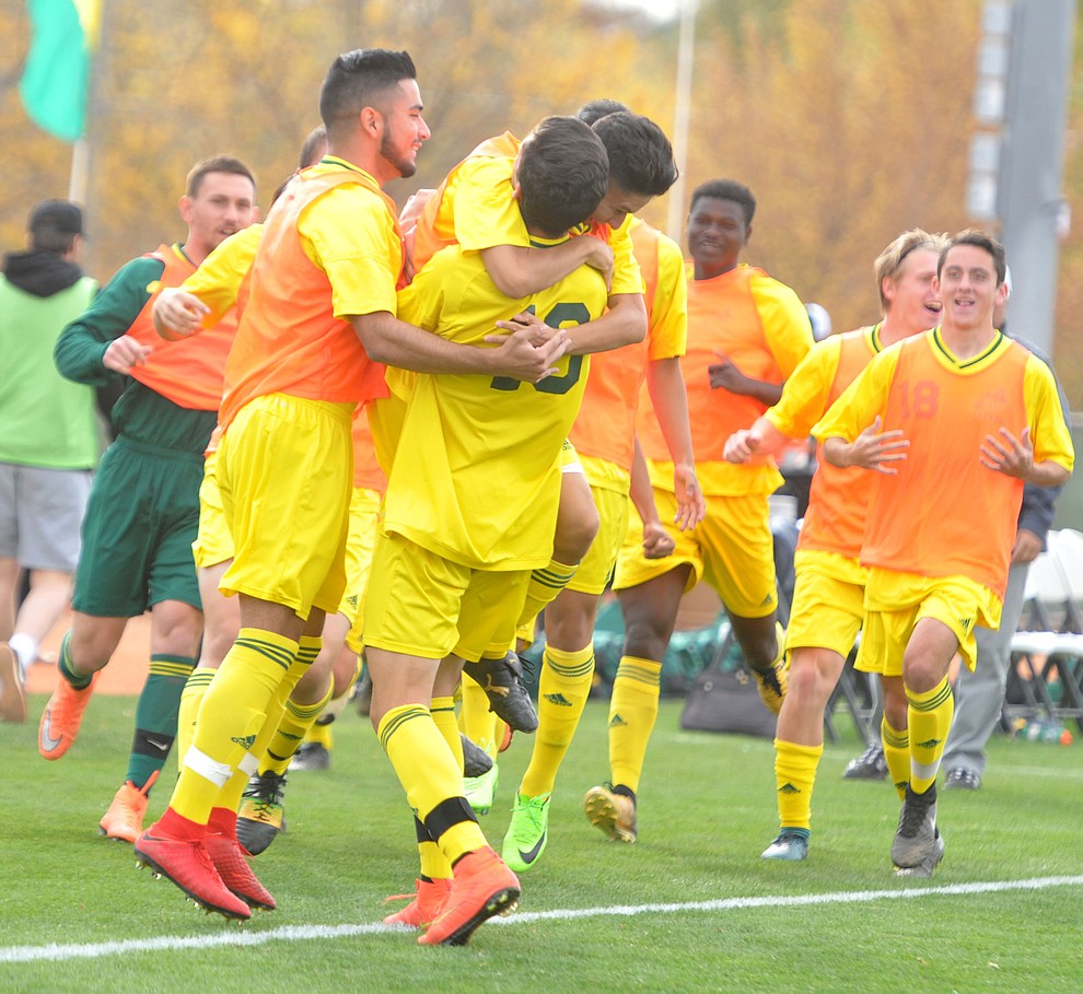 Yavapai's Carlo Quesada (10) gets mobbed by his team mates after the first goal as the Roughriders take on Mercer County Community College in the second round of the NJCAA Division 1 National Championship Wednesday afternoon in Prescott Valley. (Les Stukenberg/Courier)