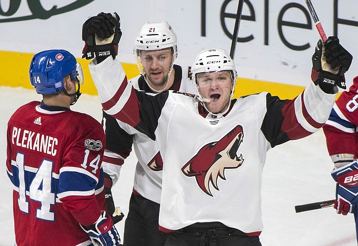 Arizona Coyotes' Christian Fischer (36) celebrates with teammate Derek Stepan (21) after scoring against the Montreal Canadiens as Canadiens' Tomas Plekanec looks on during third-period NHL hockey game action in Montreal, Thursday, Nov. 16, 2017. (Graham Hughes/The Canadian Press via AP)