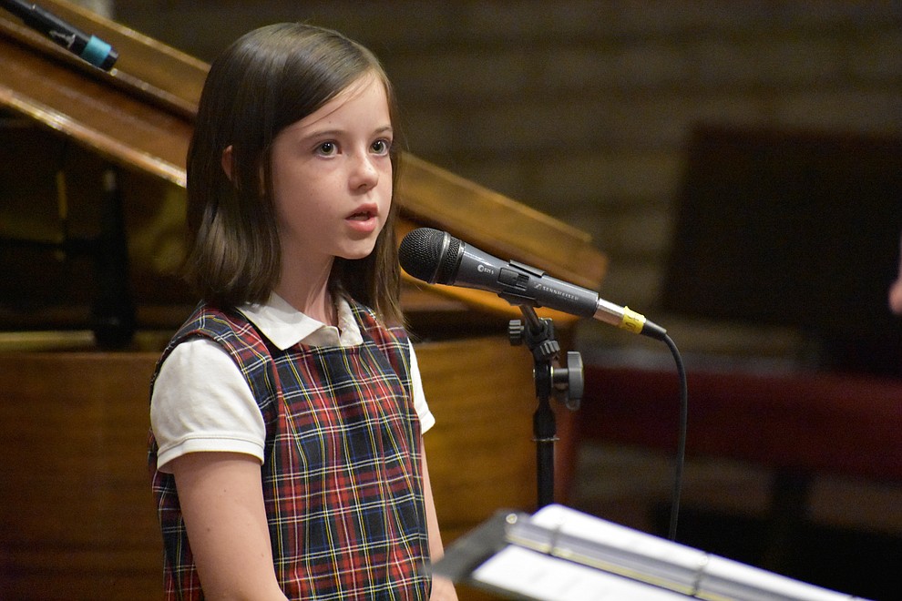 A young soloist from the Sacred Heart Choir performs during the 2017 Celebration of Thanks concert sponsored by the Quad City Interfaith Council. (Richard Haddad/WNI)