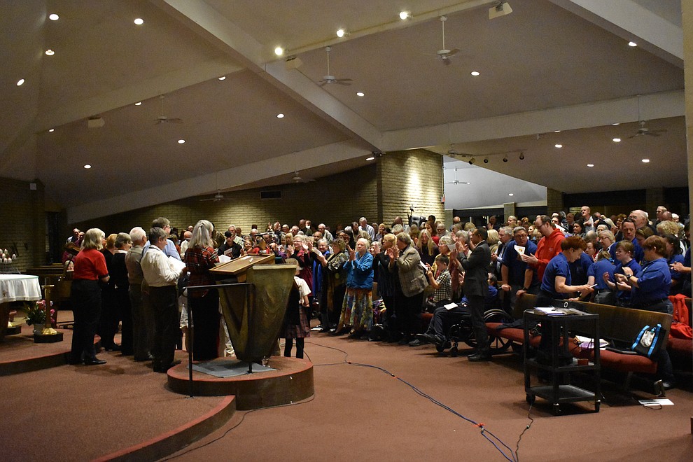 The audience stands to sing "Let There Be Peace on Earth" during the fourth annual interfaith Celebration of Thanks event on Nov. 16, 2017 at Sacred Heart Church in Prescott. (Richard Haddad/WNI)