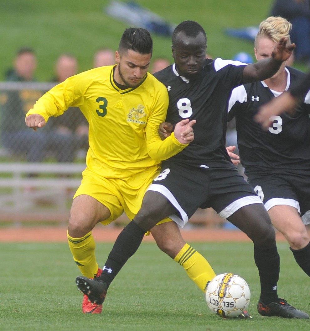 Yavapai's Ziyad Fares and Tyler's Michael Boakye battle for the ball as the Roughriders take on Tyler Community College in the semifinals of the NJCAA Division 1 Men's National Championship in Prescott Valley Friday afternoon. (Les Stukenberg/Courier)