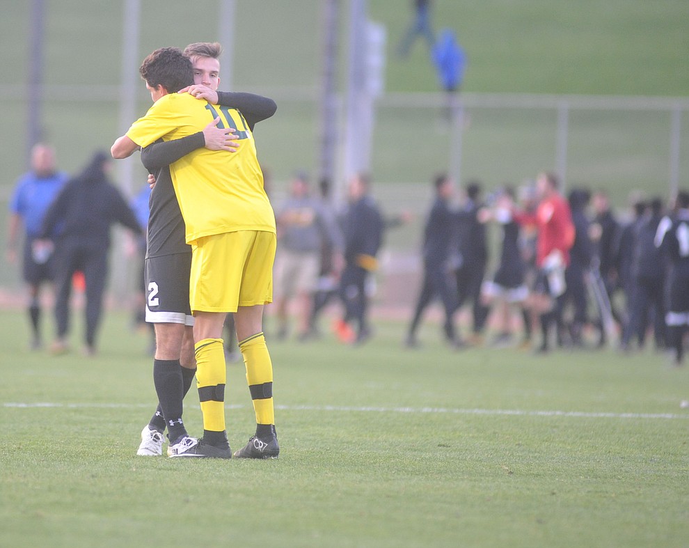 Yavapai's Carlo Quesada and Tyler's Paul Odendahl embrace after the Roughriders lost to Tyler Community College in the semifinals of the NJCAA Division 1 Men's National Championship in Prescott Valley Friday afternoon. (Les Stukenberg/Courier)