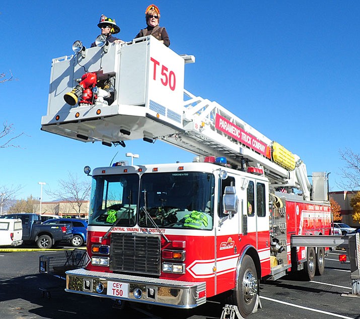 Prescott Valley Chamber of Commerce CEO Marnie Uhl and Central Yavapai firefighter Nick Fournier went up in the bucket during the 2015 Flying High Turkey Drive at the Fry's store on Glassford Hill Road in Prescott Valley as part of the Flying High Turkey Drive. For every five turkeys donated, the bucket goes another foot higher. This year’s drive — at Prescott Valley and Prescott Fry’s stores — is Monday, Nov. 20. (Les Stukenberg/Courier, file)