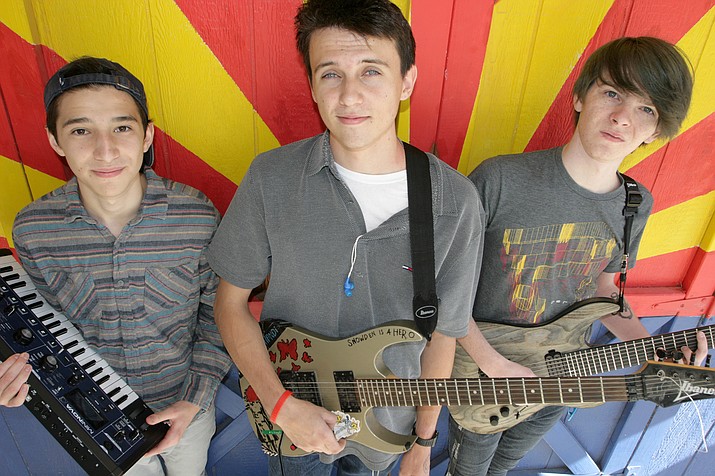 Dartagnon Woodruff, center, a senior at American Heritage Academy in Cottonwood, has scheduled a Nov. 25 Battle of the Bands to raise money for Cottonwood’s Y.E.S. the Arc. Woodruff’s band will play against band led by Matt Amato, left, and James Rogers, right. (Photo by Bill Helm) 
