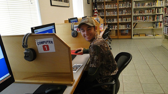Dustin Corder works in the library on his Career Online High School prerequisites. His goal eventually is to get a job in the Homeland Security field. (Courtesy)