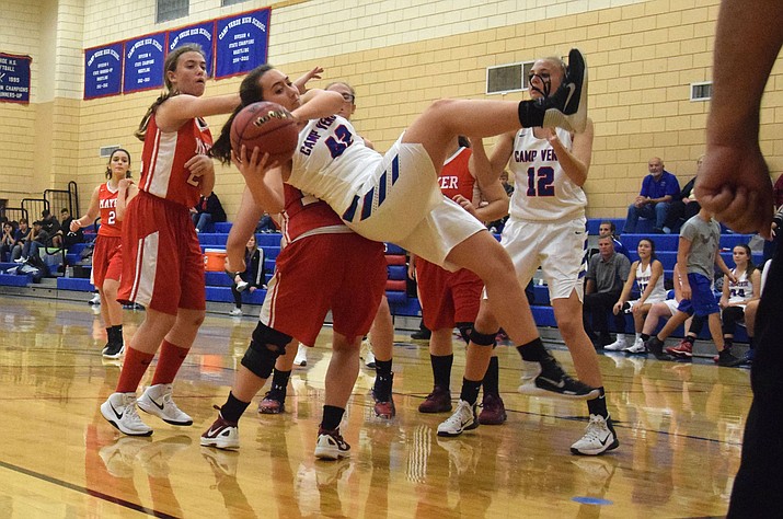 Camp Verde sophomore Bennett Holm  gets fouled by a Wildcat during the Cowboys’ 48-17 win on Tuesday night. (VVN/James Kelley)