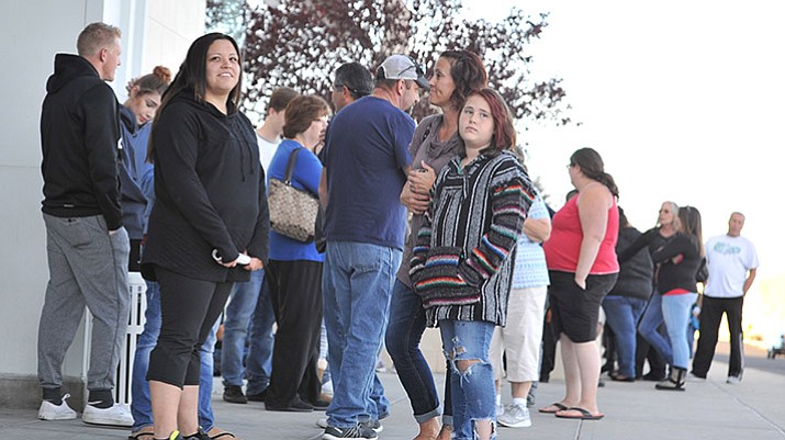 Ashley Rodriguez, front left, waited since 10:30 a.m. Thursday for the Kohl’s store opening at 5 p.m. to get two game systems during the early Black Friday shopping in Prescoatt Valley on Thanksgiving Day. By the time the store opened there were over 250 people in line. (Les Stukenberg/Courier)