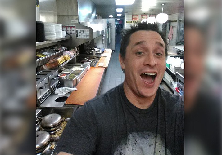 Alex Bowen poses in the kitchen at a Waffle House in West Columbia, S.C. When Bowen found the only worker at the empty South Carolina Waffle House asleep, he took his meal into his own hands. Bowen chronicled with selfies how he made his own double Texas bacon cheese steak melt on Facebook.