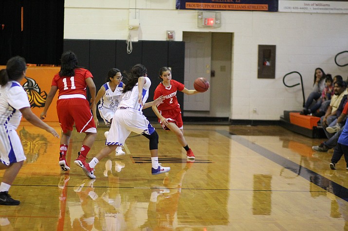 Cayli Miles dribbles around a Bruins defender.