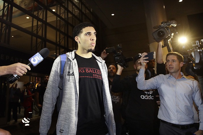 UCLA basketball player LiAngelo Ball is surrounded by reporters and photographers as he leaves Los Angeles International Airport on Tuesday, Nov. 14, 2017, in Los Angeles. (Jae C. Hong/AP)