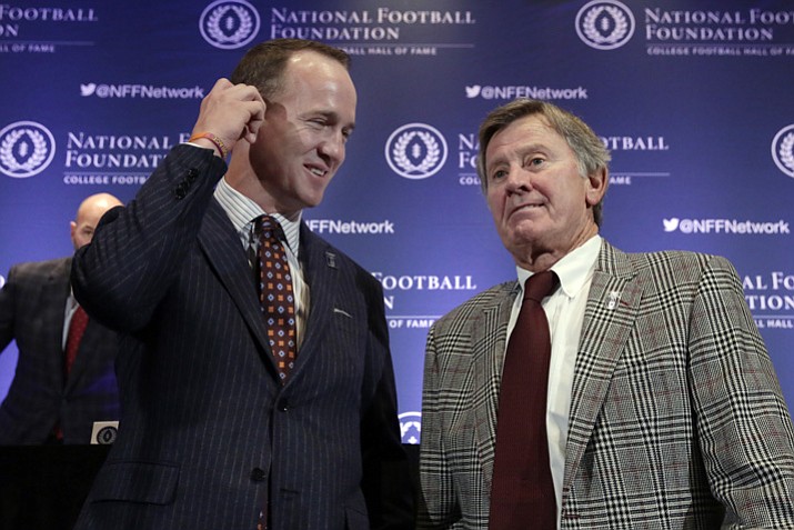 Former University of Tennessee football quarterback Peyton Manning, left, and former University of Florida football quarterback Steve Spurrier get together after a news conference of the National Football Foundation and College Football Hall of Fame in New York Tuesday, Dec. 5, 2017. (Richard Drew/AP)