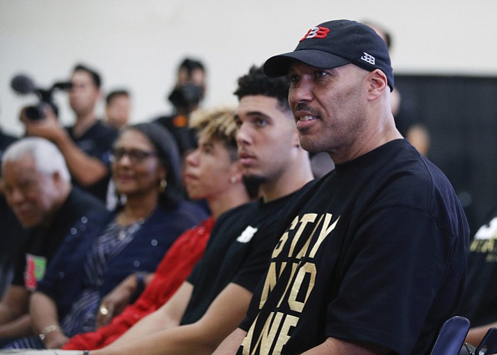 In this June 23, 2017, file photo, LaVar Ball, right, father of Los Angeles Lakers draft pick Lonzo Ball, listens to his son during the NBA basketball team's news conference in El Segundo, Calif. Mr. Ball removed his son, LiAngelo, from UCLA on Monday, Dec. 4, 2017. (Jae C. Hong, File/AP)