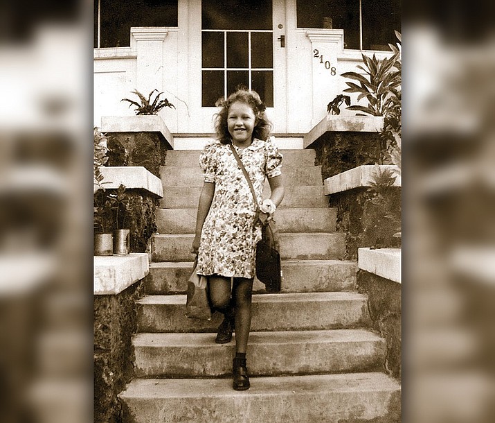 A young Lois Elizabeth Albright heading to school with her lunch and gas mask. (Courtesy)