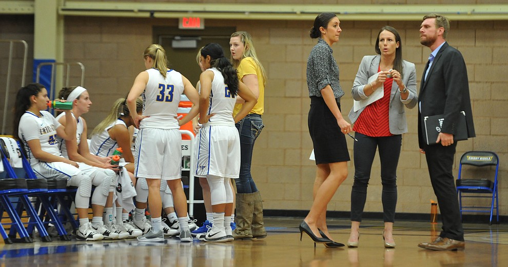 ERAU's coaching staff, from left, Rachel Galligan, Becky Burke and Travis Steadman confer at the end of the first quarter,  as the Eagles take on Benedictine Mesa in womens basketball Thursday night in Prescott. (Les Stukenberg/Courier)