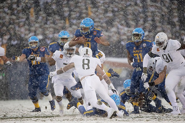Navy’s Malcolm Perry (10) runs the ball against Army during the first half of an NCAA college football game, Saturday, Dec. 9, in Philadelphia. (Matt Rourke/AP)